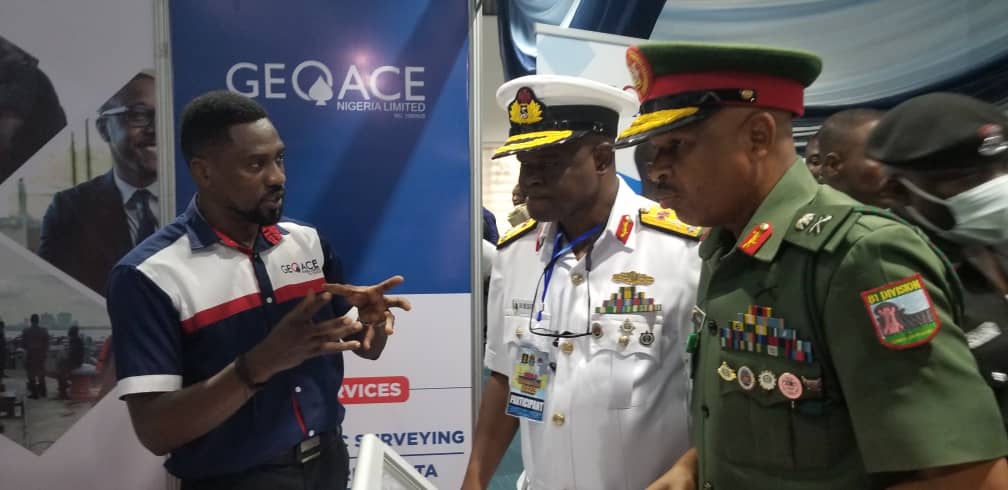 Geoace staff briefing Nigerian Navy and Army officers at an exhibition